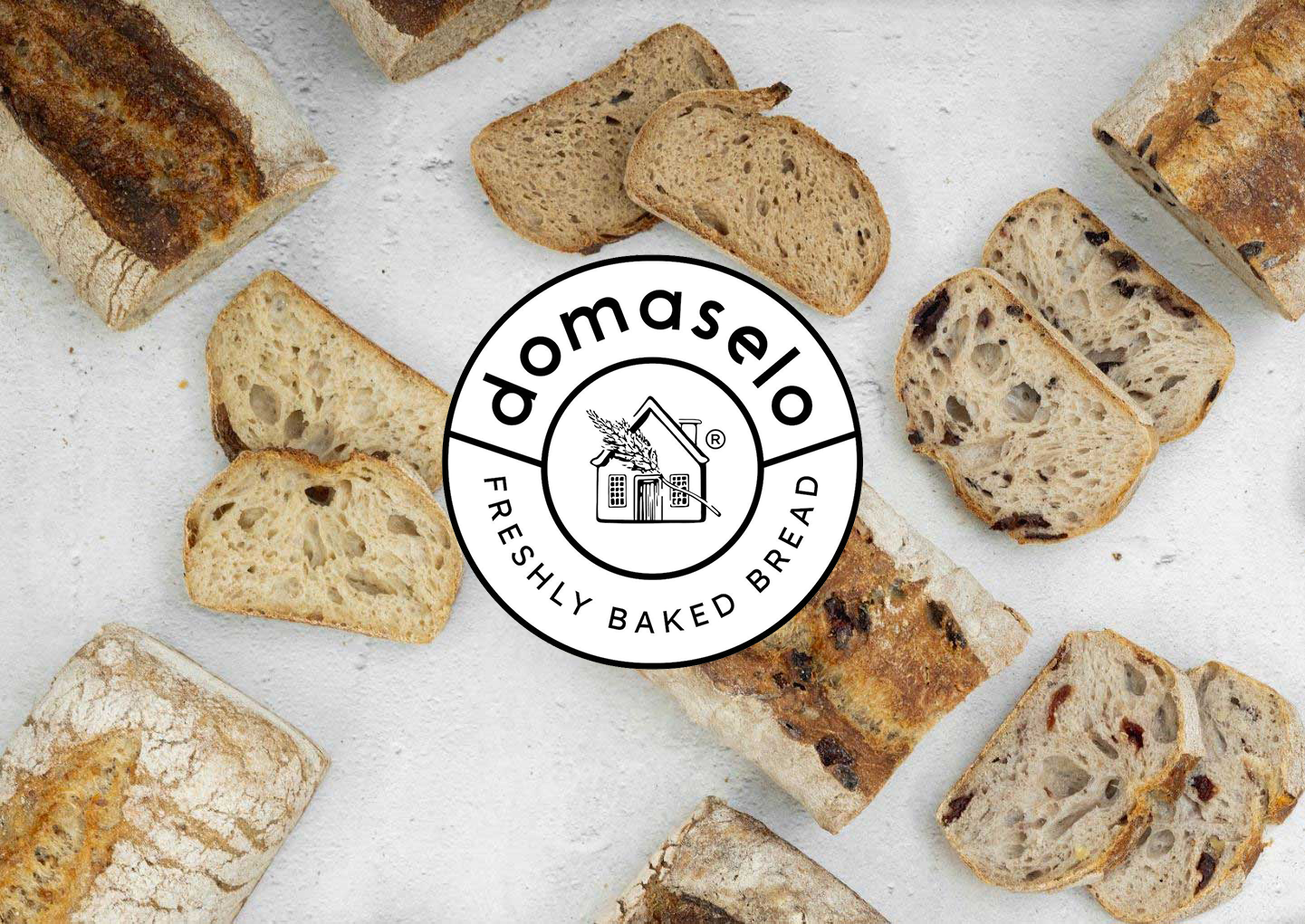 domaselo logo on top of assorted domaselo breads