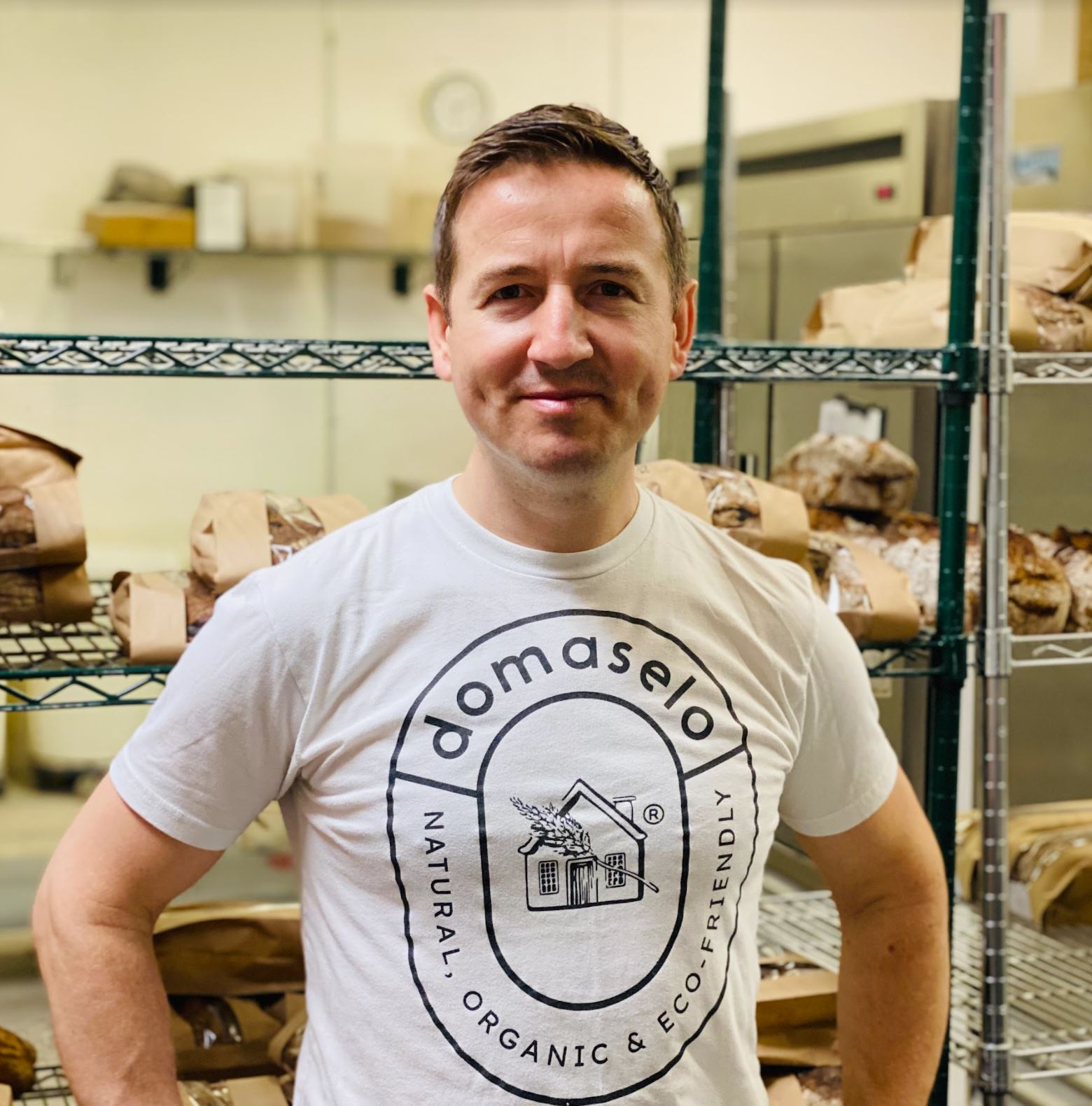 Emil wearing a Domaselo bread t shirt in the bakery