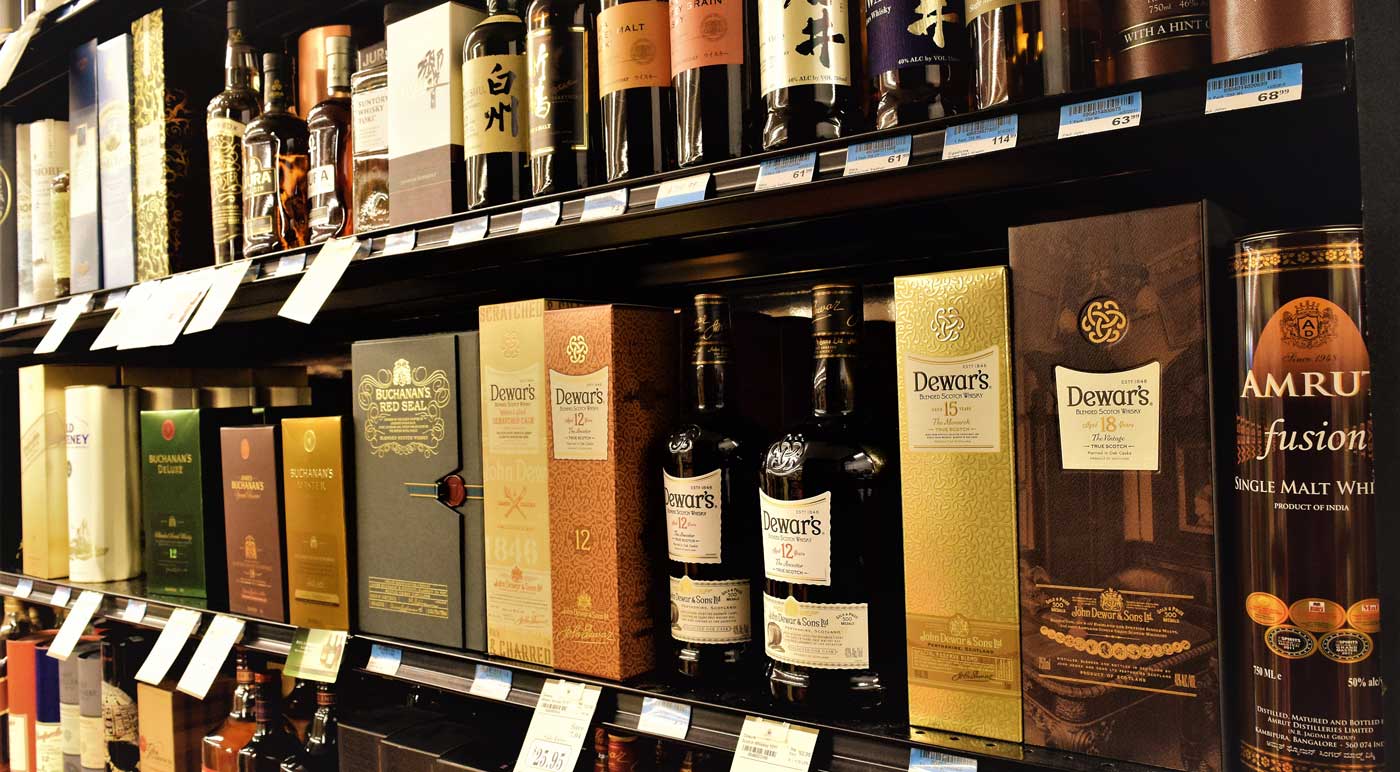 liquor shelf items on stock in Grove Liquors Milam's Markets store location