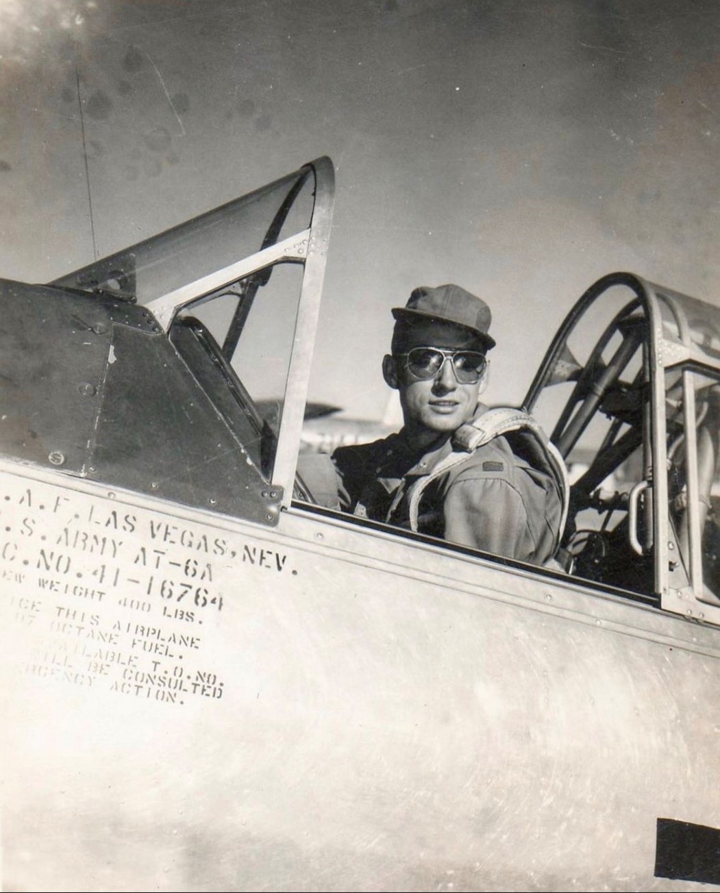 black and white picture of man flying a plane